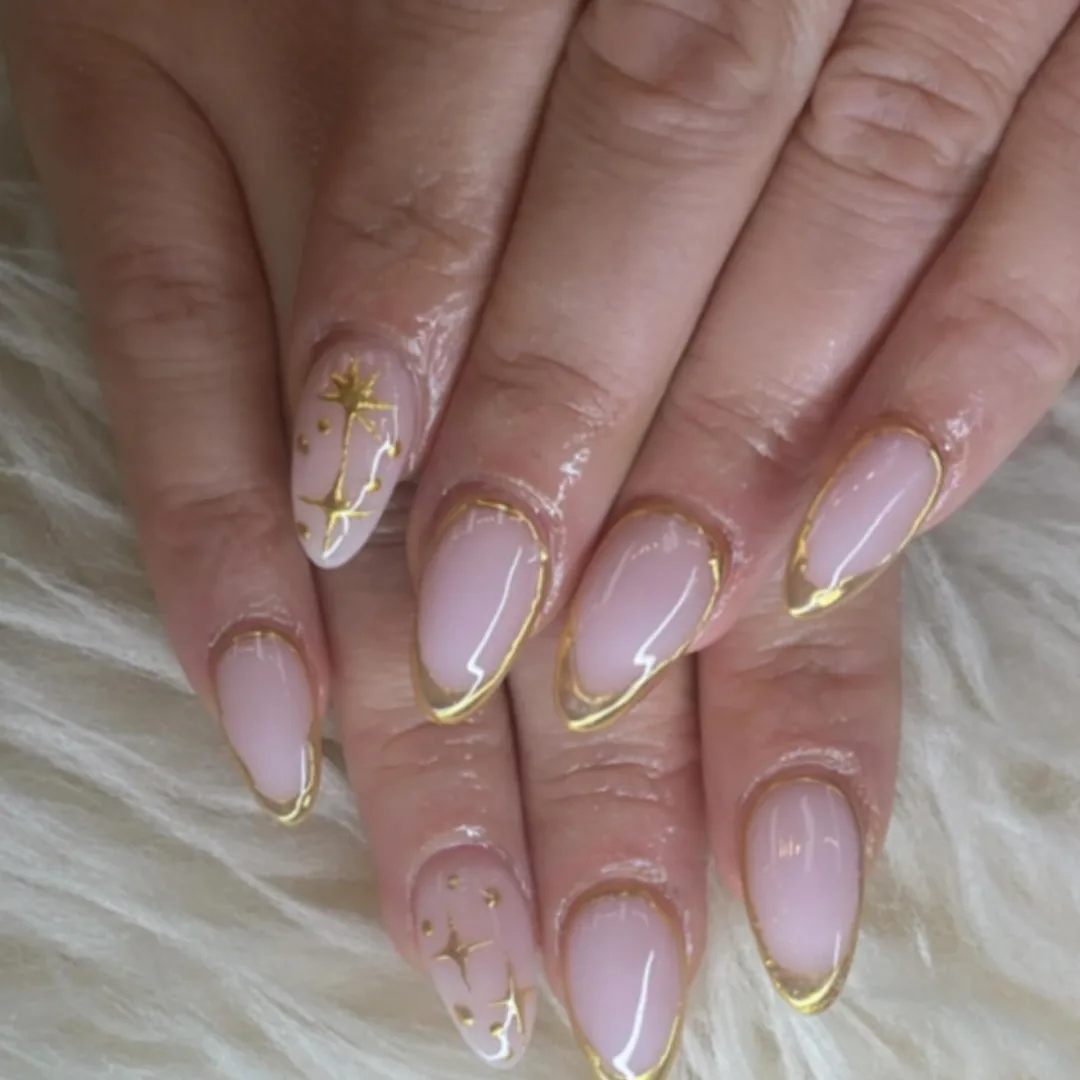 Blush almond nails with fine gold French tips by Your Way Nail Spa