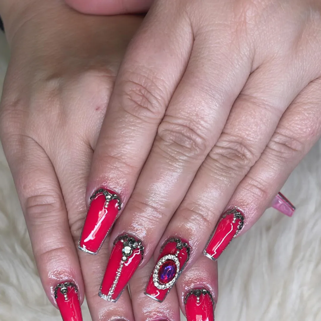Ruby red coffin nails with jewel and silver details by Your Way Nail Spa