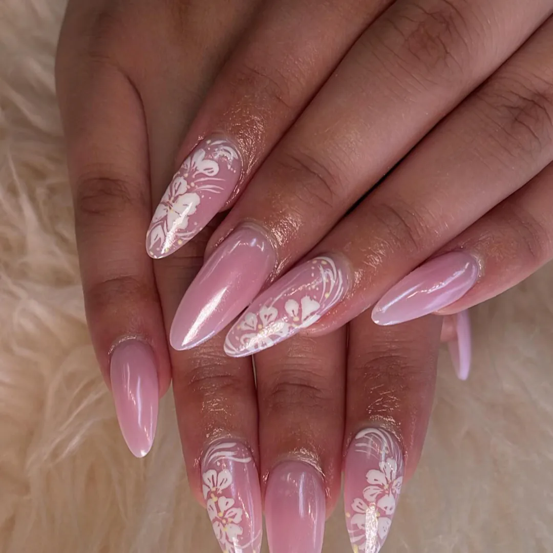 Blush pink almond nails with white hibiscus details by Your Way Nail Spa