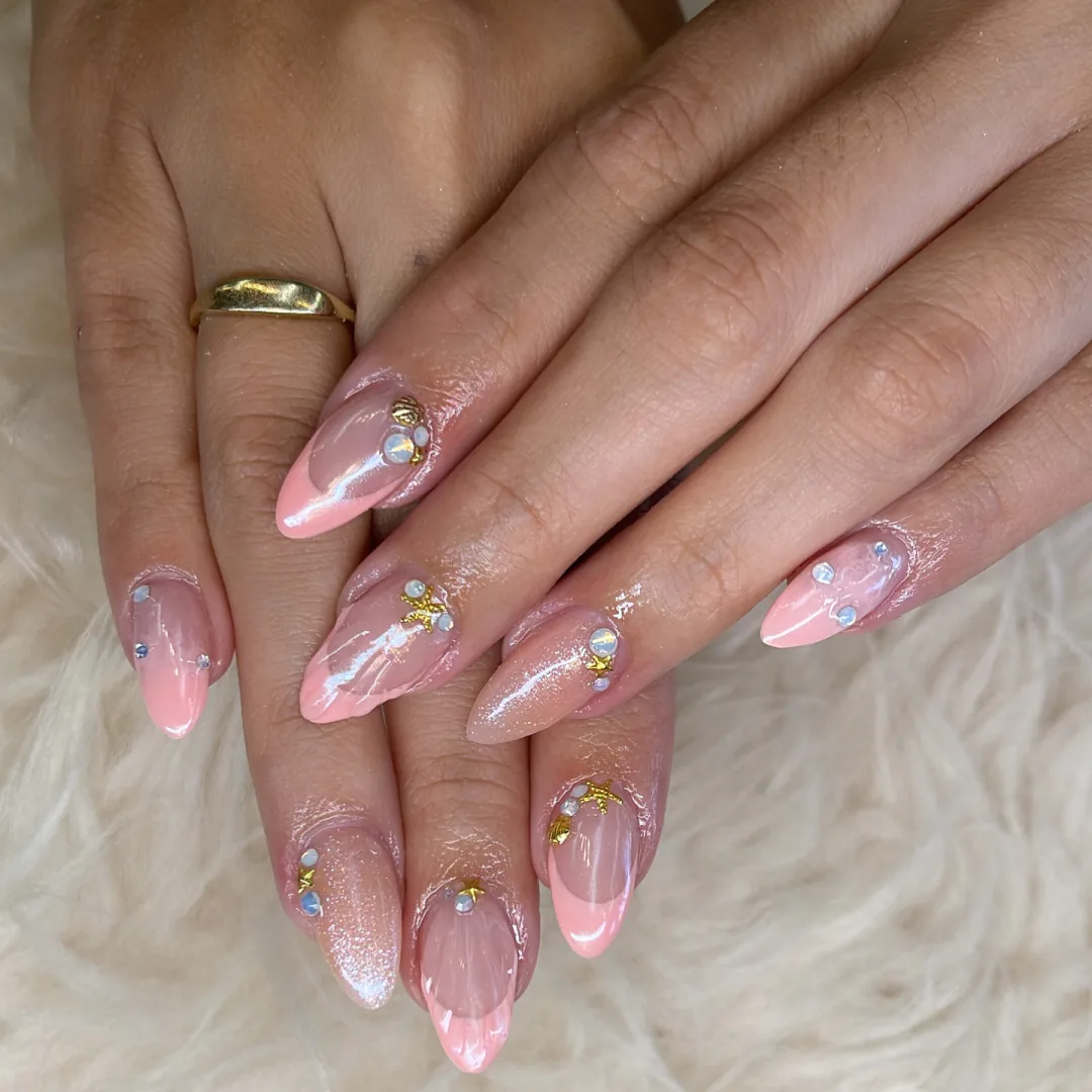 Seashell pink almond nails with gold starfish charms by Your Way Nail Spa