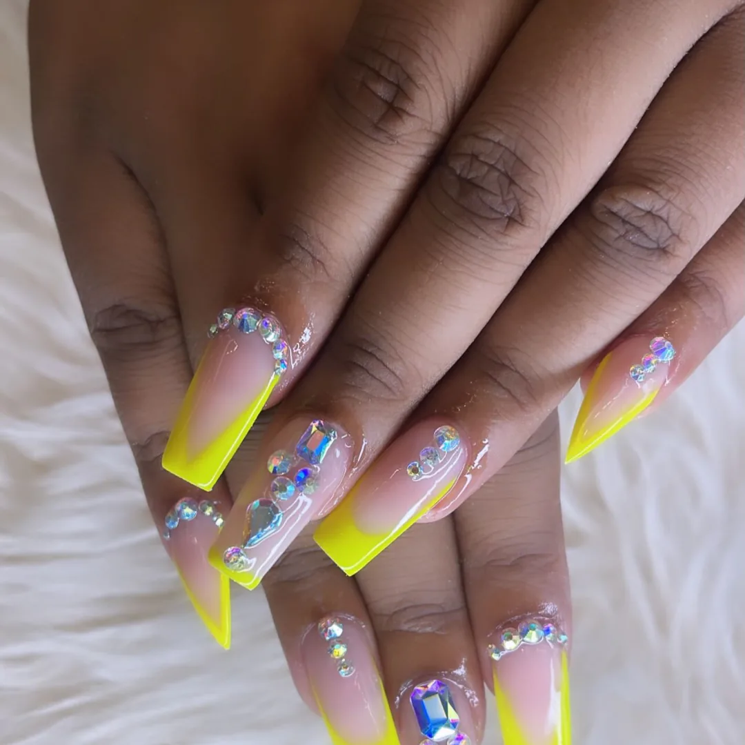 Neon yellow French coffin nails with iridescent crystals by Your Way Nail Spa