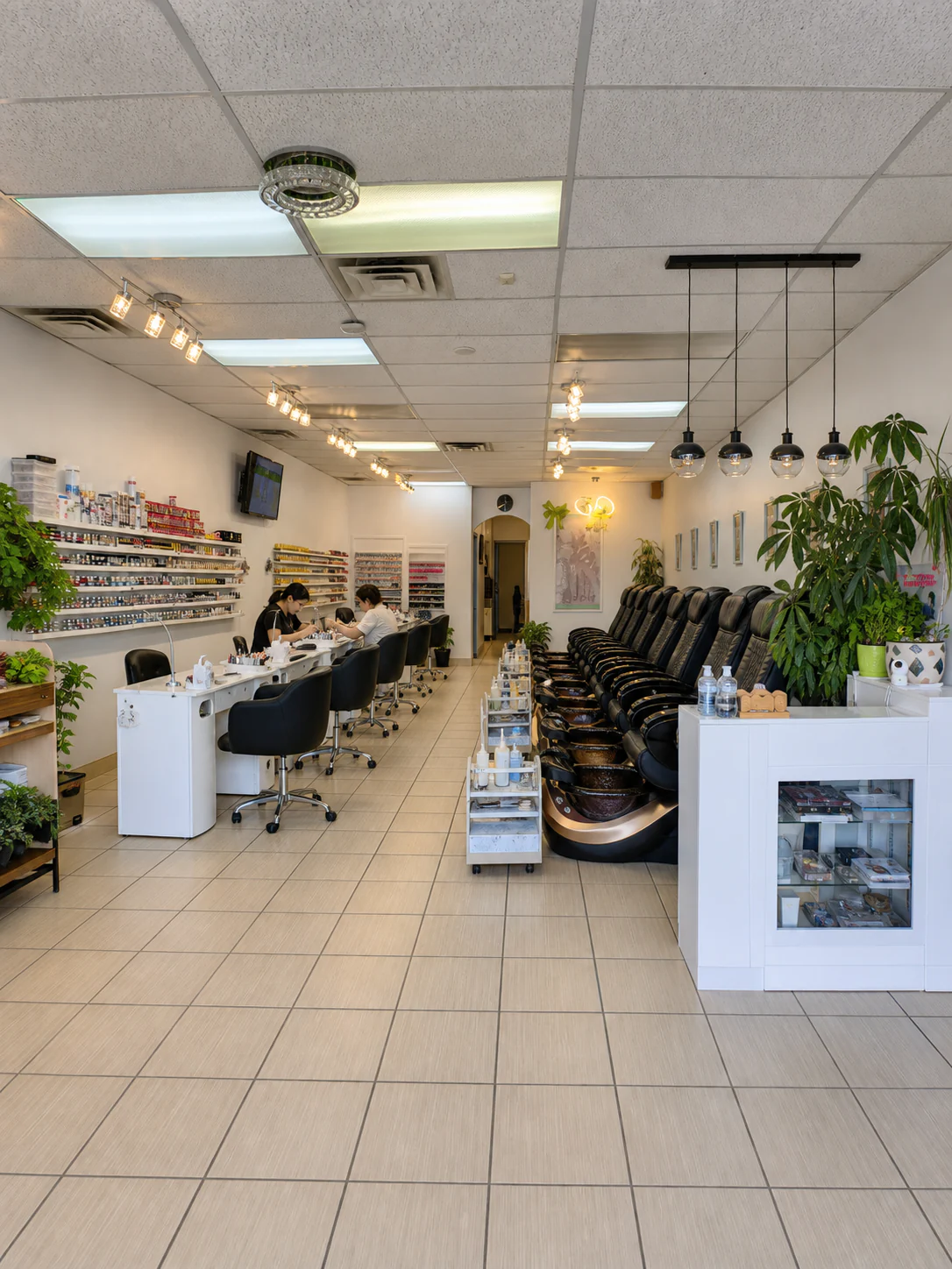 Entrance view showing the reception, manicure tables, and pedicure chairs at Your Way Nail Spa