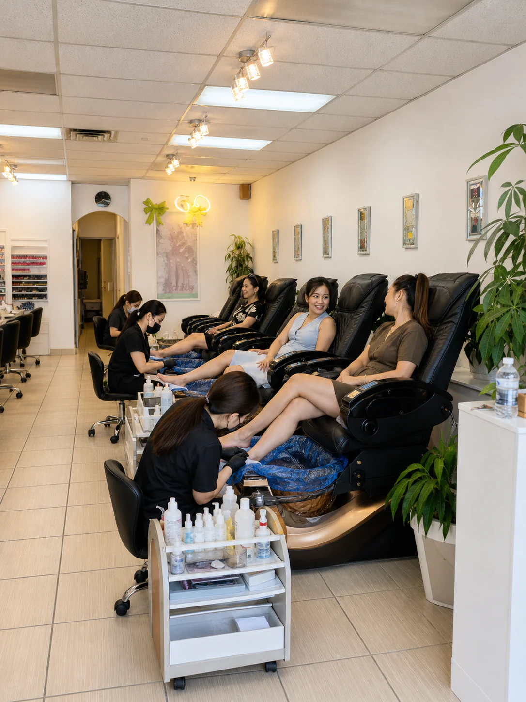 Clients chatting while technicians provide clean pedicure services at Your Way Nail Spa